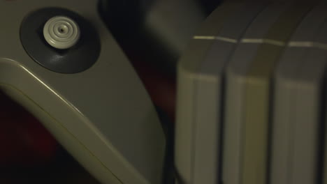 nintendo 64 controller and games set on shelf by unidentifiable hand