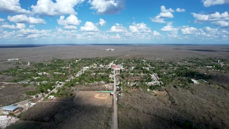 backwards drone shot of tahmek town during heavy drought in yucatan mexico