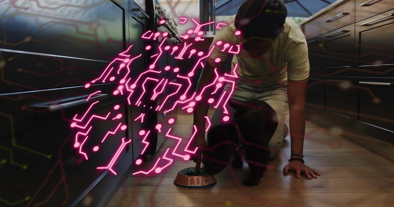 Man entering kitchen holding bowl and activating pink circuit overlay feeding puppy via technology