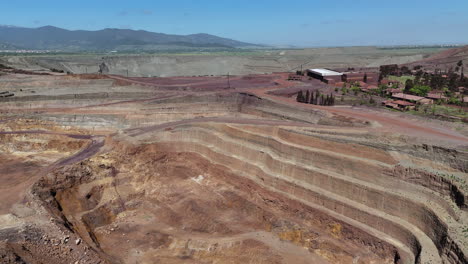 aerial descending view over an open pit mine in andalusia, spain.