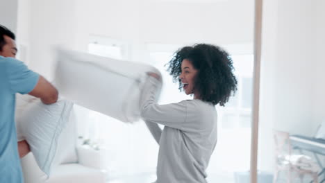 Pillow-fight,-interracial-couple