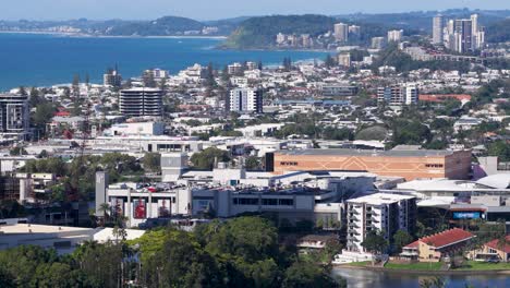 drone footage captures urban landscape, roads, and coastline under clear skies with vibrant colors and dynamic movement
