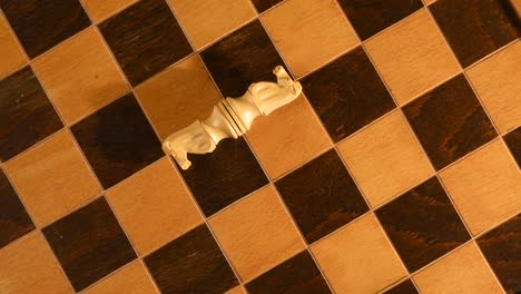 white knights from chess set, losing a strategic game of chess