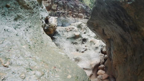 exploring deep and narrow natural gorge formations in palawan philippines - moving forward close to rock formations in slow motion