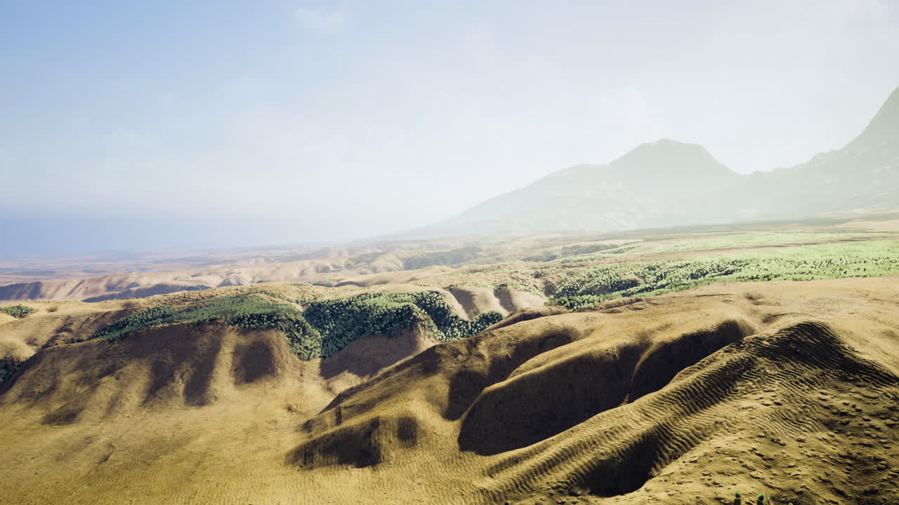 Scenic view of rolling hills and valleys under clear sky at dawn