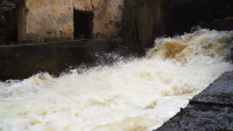 splashing and foamy river water crashing down the waterfall in slow motion