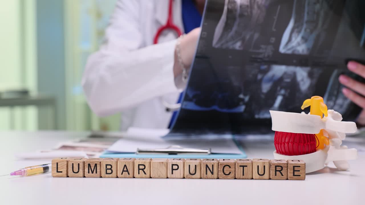 Medical Professional Reviewing Lumbar Puncture Procedure with MRI and Spinal Model