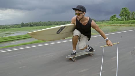 longboarder skitching with surfboard in tropics