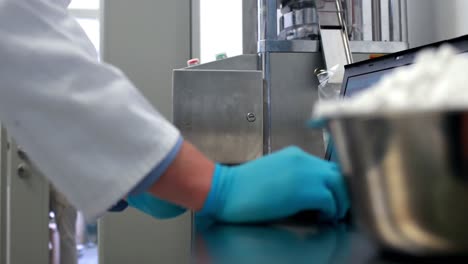 pharmacist using heavy machinery to make medicine