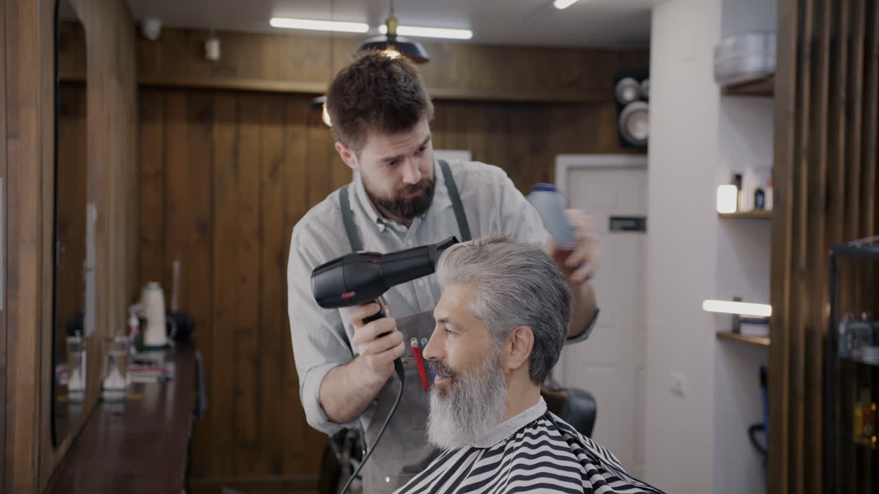 Barber giving a senior a haircut