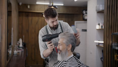 barber giving a senior a haircut