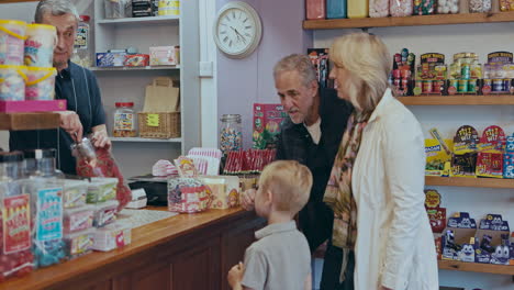 people buying sweets in a traditional candy store
