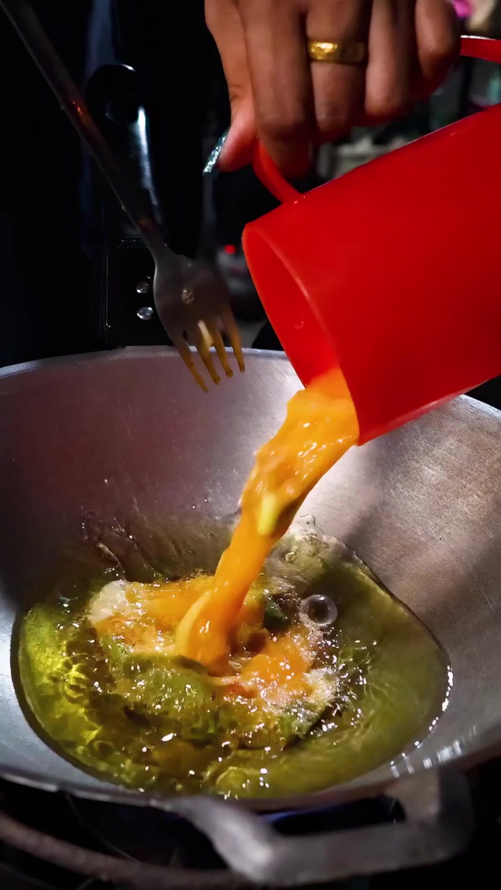 Cooking an omelet in a street food stall