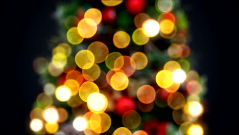 defocused new year tree lights blinking seamless on black background. looped 3d animation. merry christmas and happy new year concept.