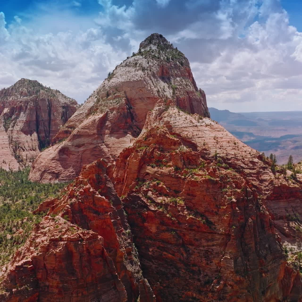 Pointed tops of mountains in the light of bright sunshine. Canyons of Zion National Park in Utah, USA from aerial perspective
