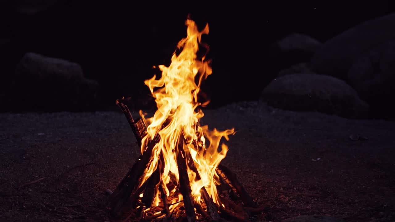 Bonfire that burns on a dark background, wood burning flame.