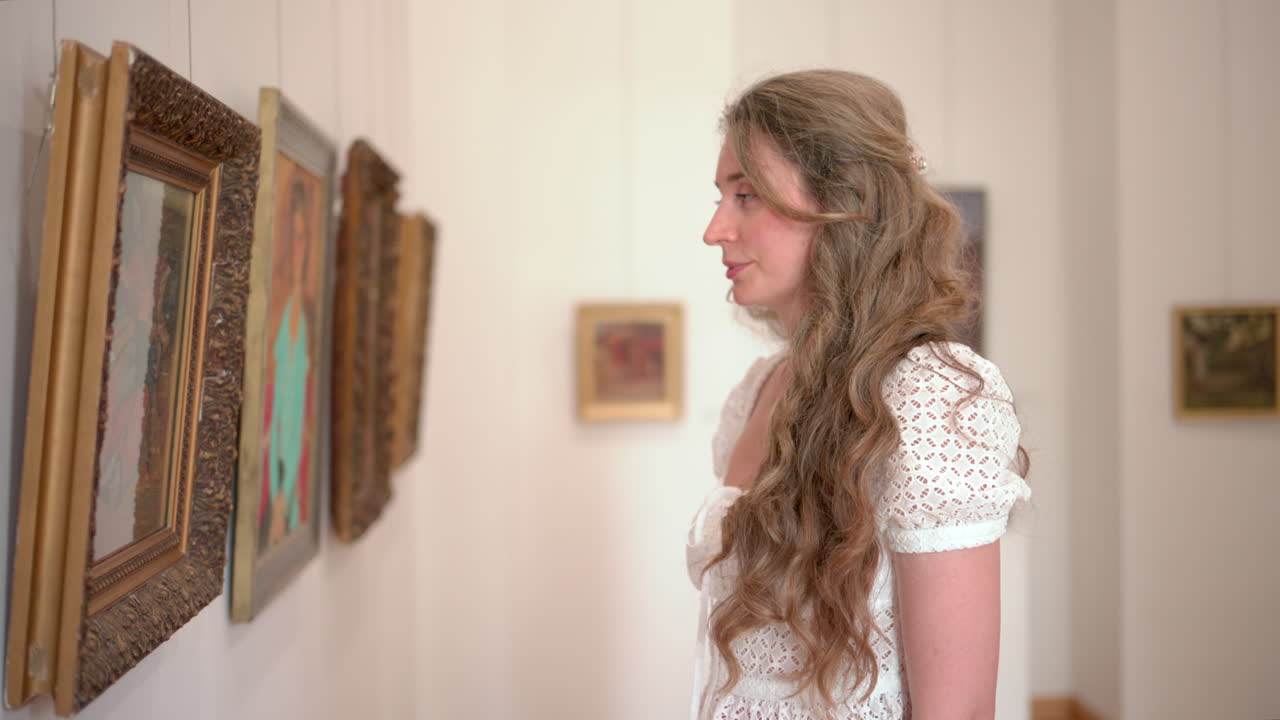 Woman visiting an art museum, admiring paintings