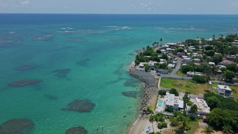 aerial: loiza with sand beach and atlantic ocean during the day in puerto rico, usa, push in drone shot