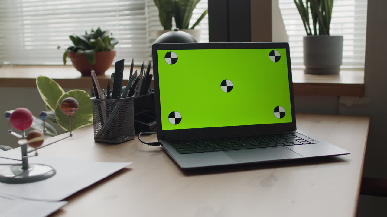 Laptop with Green Screen Calibration on a Desk