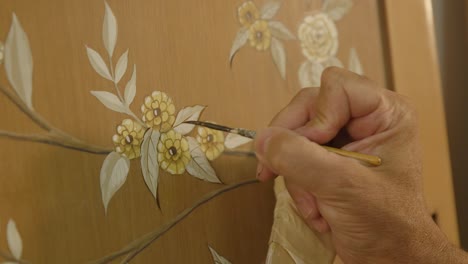 painting a design over a furniture by hand