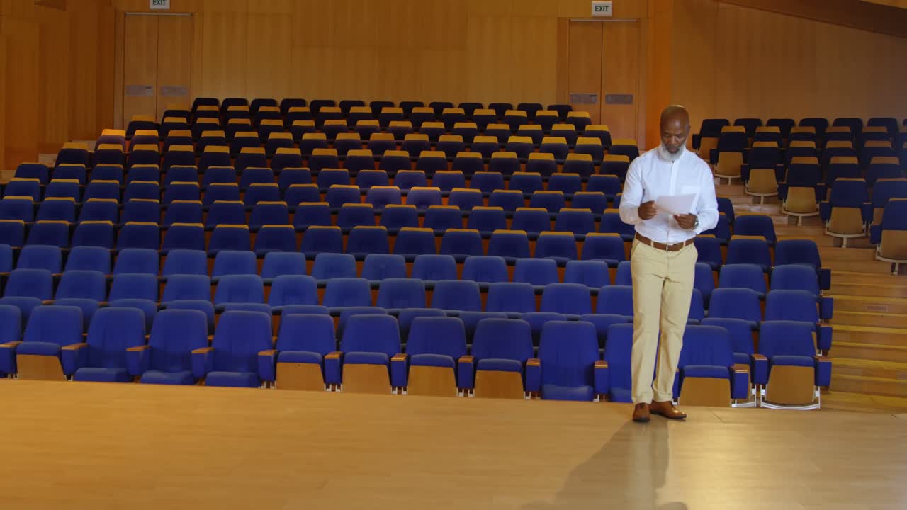 African American businessman practicing speech in empty auditorium 4k