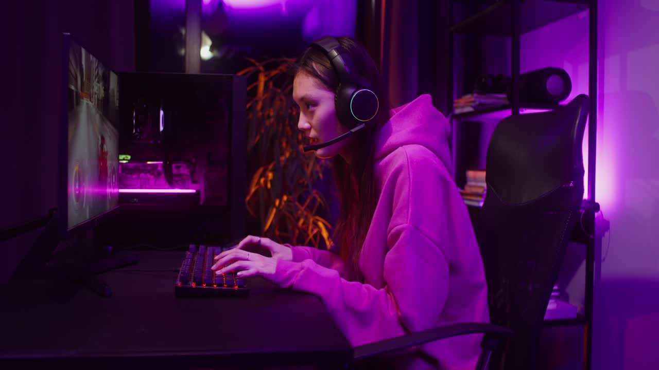 Woman playing video games at her computer