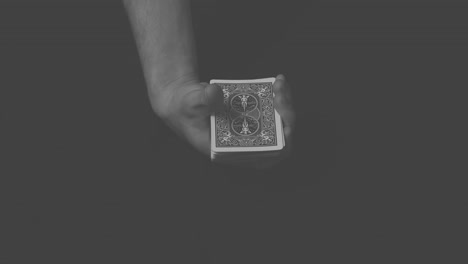 close-up of a magician performing a simple card trick.