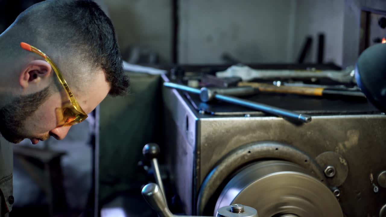 Worker in industrial plant. Portrait of factory worker standing by machine in industrial workshop