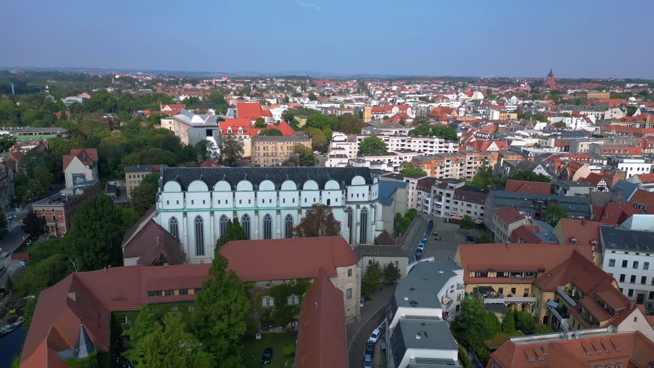 Dome to halle in the city in germany is shining on a sunny summer day. Spectacular aerial view flight static tripod hovering drone