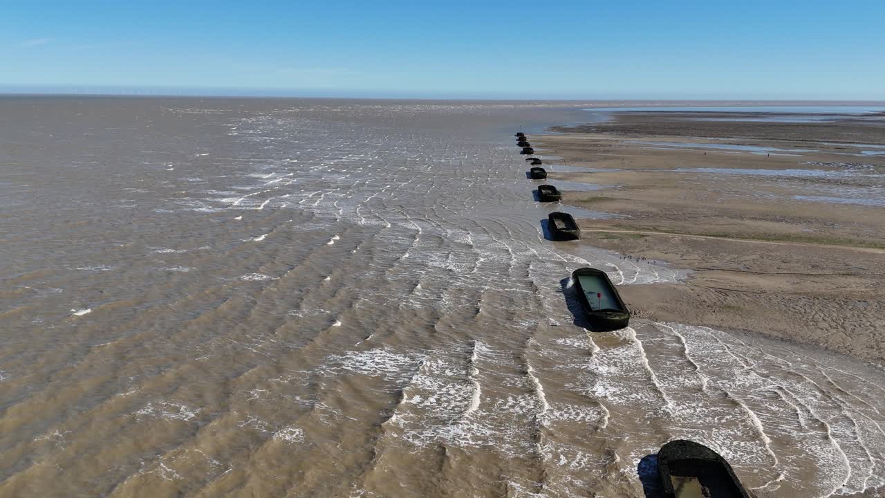 Row of Barges on River Blackwater Essex UK used for WW2 target practice