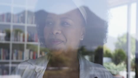 thoughtful african american plus size woman looking through window, unaltered, slow motion