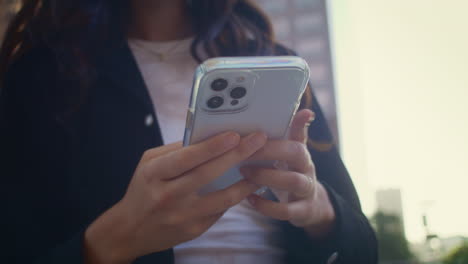 Unknown-woman-hands-holding-modern-smartphone-close-up.-Girl-use-phone-outdoors