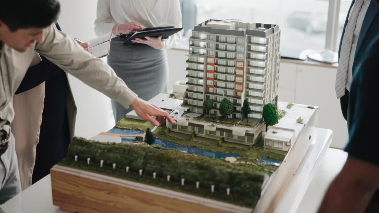 Architects discussing a building model