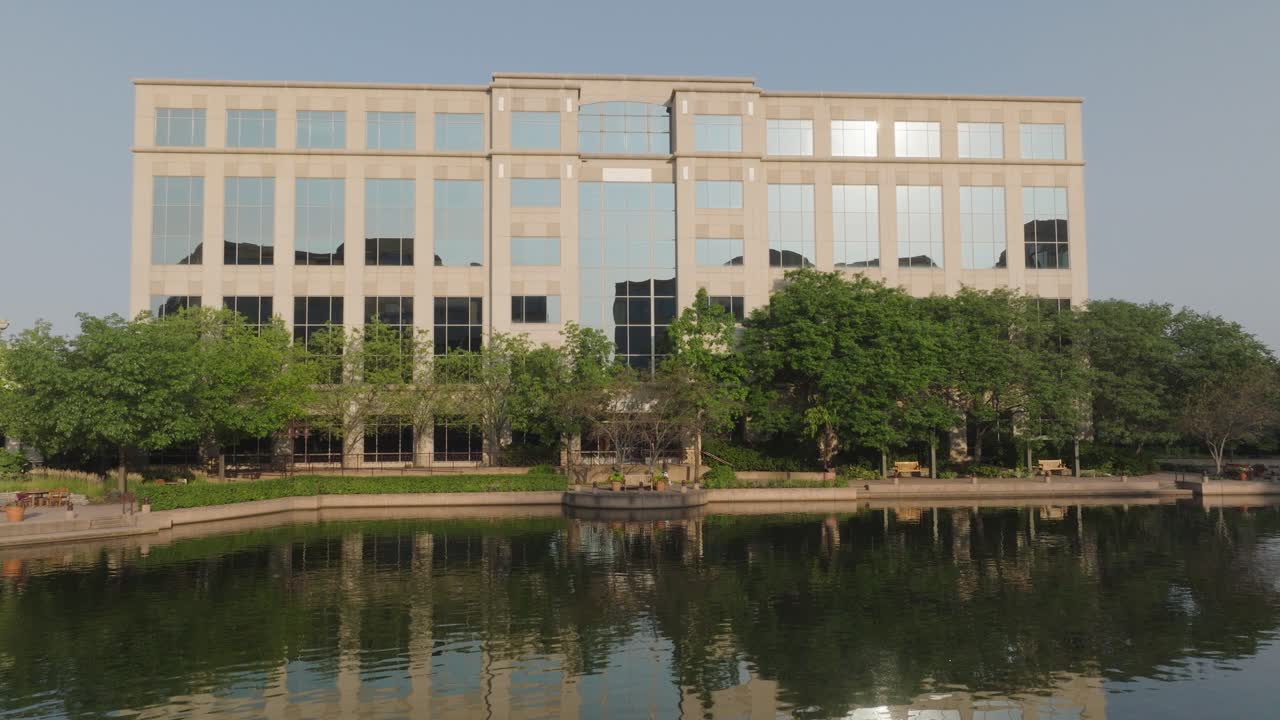 Front view of Centennial Lakes Office Park with glass windows reflecting sunlight in Edina Minnesota of USA. Lakefront.