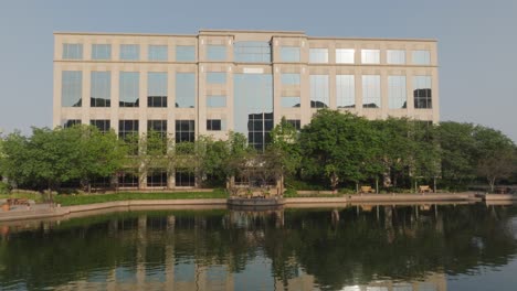 front view of centennial lakes office park with glass windows reflecting sunlight in edina minnesota of usa. lakefront.