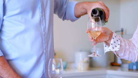 man pouring champagne into glass at home 4k