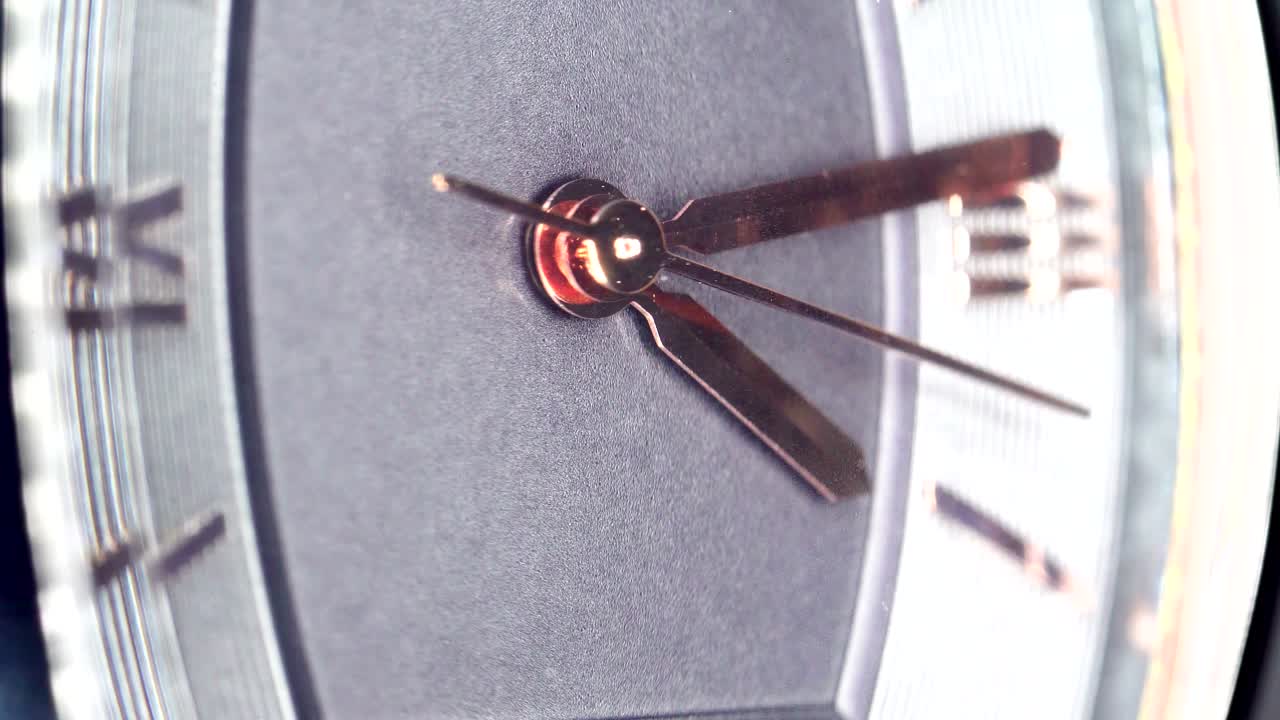 The golden second hand of the wrist watch on a macro shot