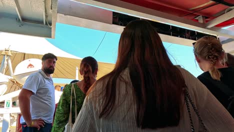 people boarding a boat at a dock