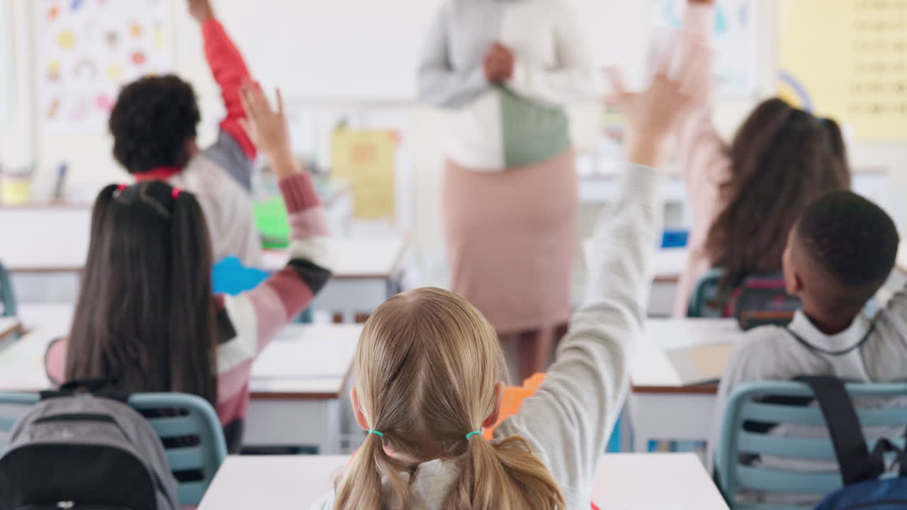 Students raising hands in classroom