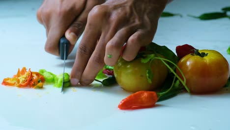 pimienta de chile de bombay siendo cortada con precisión por un chef