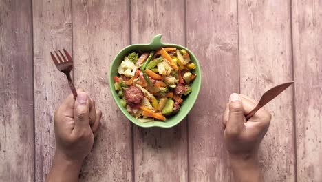 mixed vegetable stir-fry with fork and knife