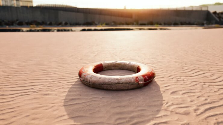 Lifebuoy on the city beach at sunset