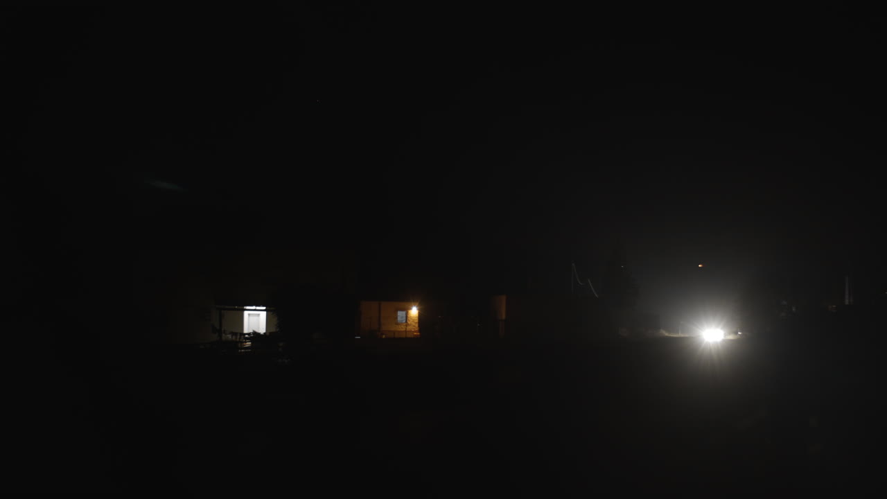 Car on countryside road at pitch dark night