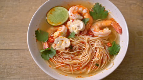 noodles with spicy soup and shrimps in white bowl - asian food style