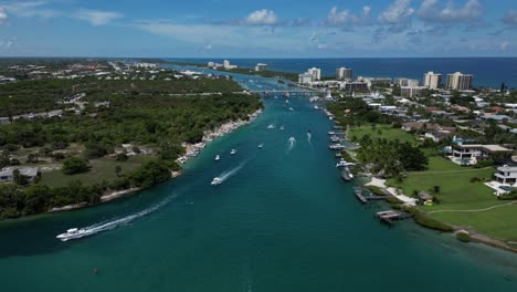 aerial drone footage with speed boats traveling along the indian river on a beautiful day in florida