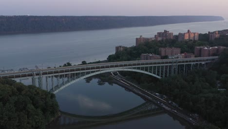 gorgeous aerial orbit of the henry hudson bridge at the tip of manhattan in new york city at sunrise blue hour