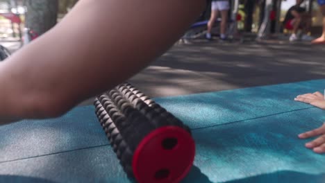 woman foam rolling legs