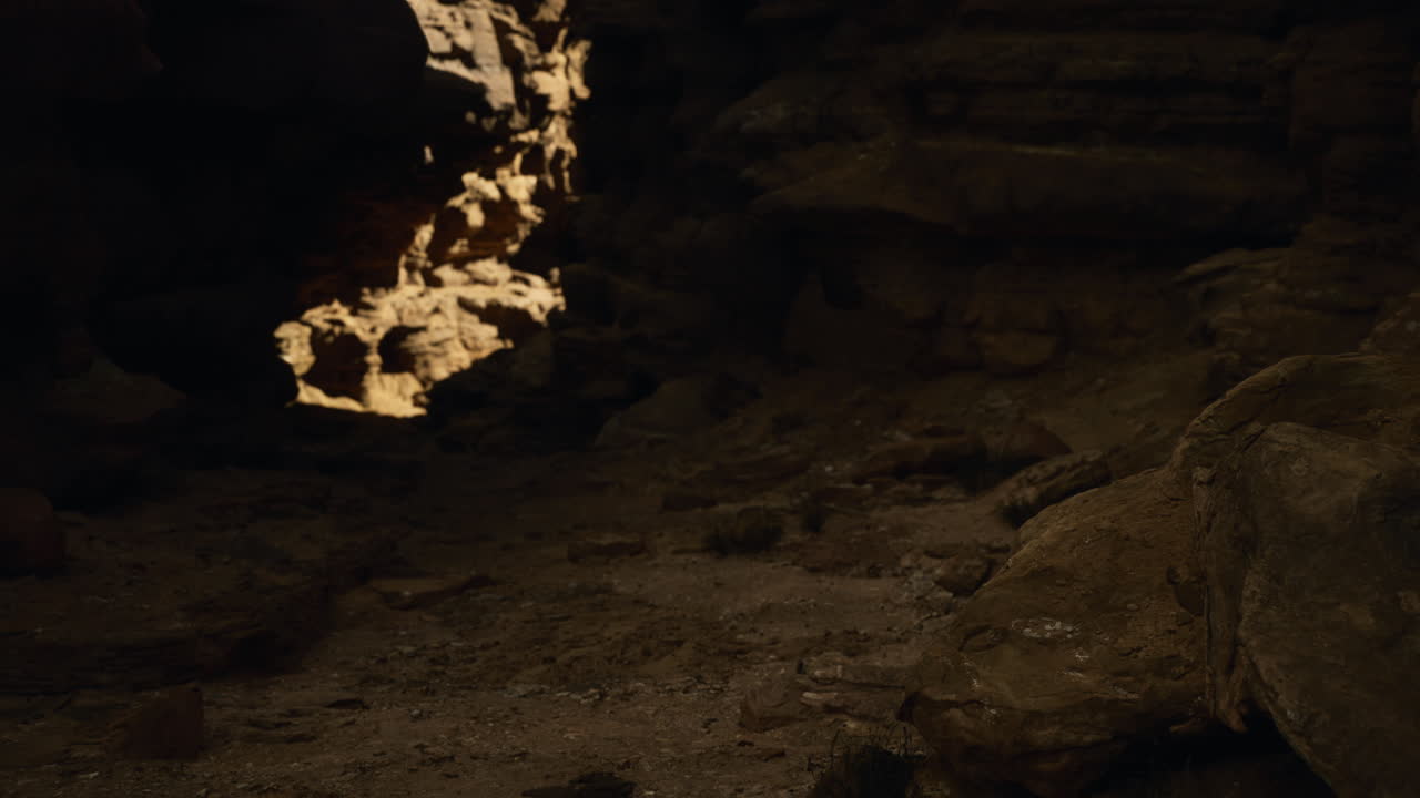 Sunlight shining into a dark cave revealing rocky formations