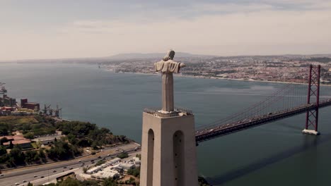 christ the king statue in almada overlooking lisbon, portugal, aerial view