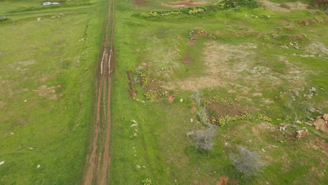 aerial footage of a truck moving on dirt road near the lake, a lovely off road scenario, muak klek, saraburi, thailand